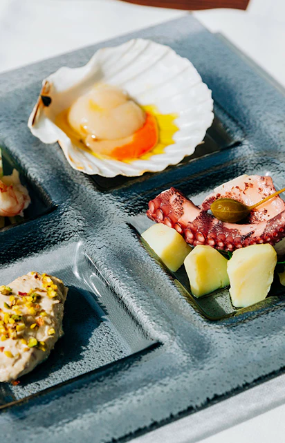 Venetian cicchetti platter with seafood and wine at illy Caffè, St. Mark's Square, Venice.