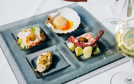 Venetian cicchetti platter with seafood and wine at illy Caffè, St. Mark's Square, Venice.