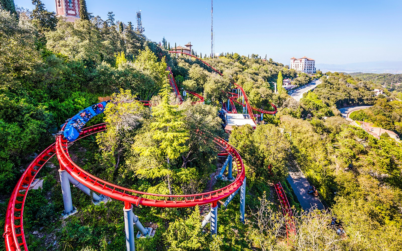 Roller coaster winding through trees at Tibidabo Amusement Park, Barcelona.