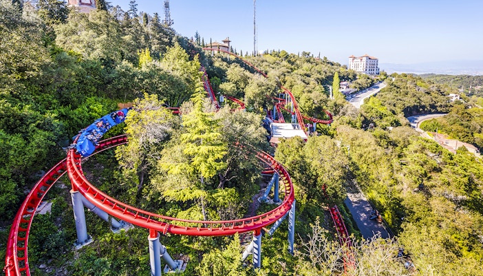 Roller coaster winding through trees at Tibidabo Amusement Park, Barcelona.