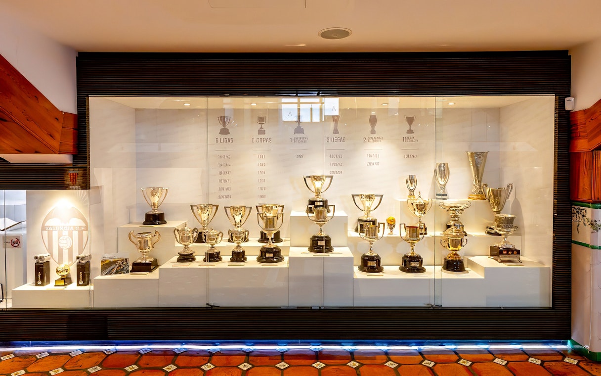 Valencia CF trophy display at Mestalla Forevertour in Valencia, showcasing various football cups and awards.