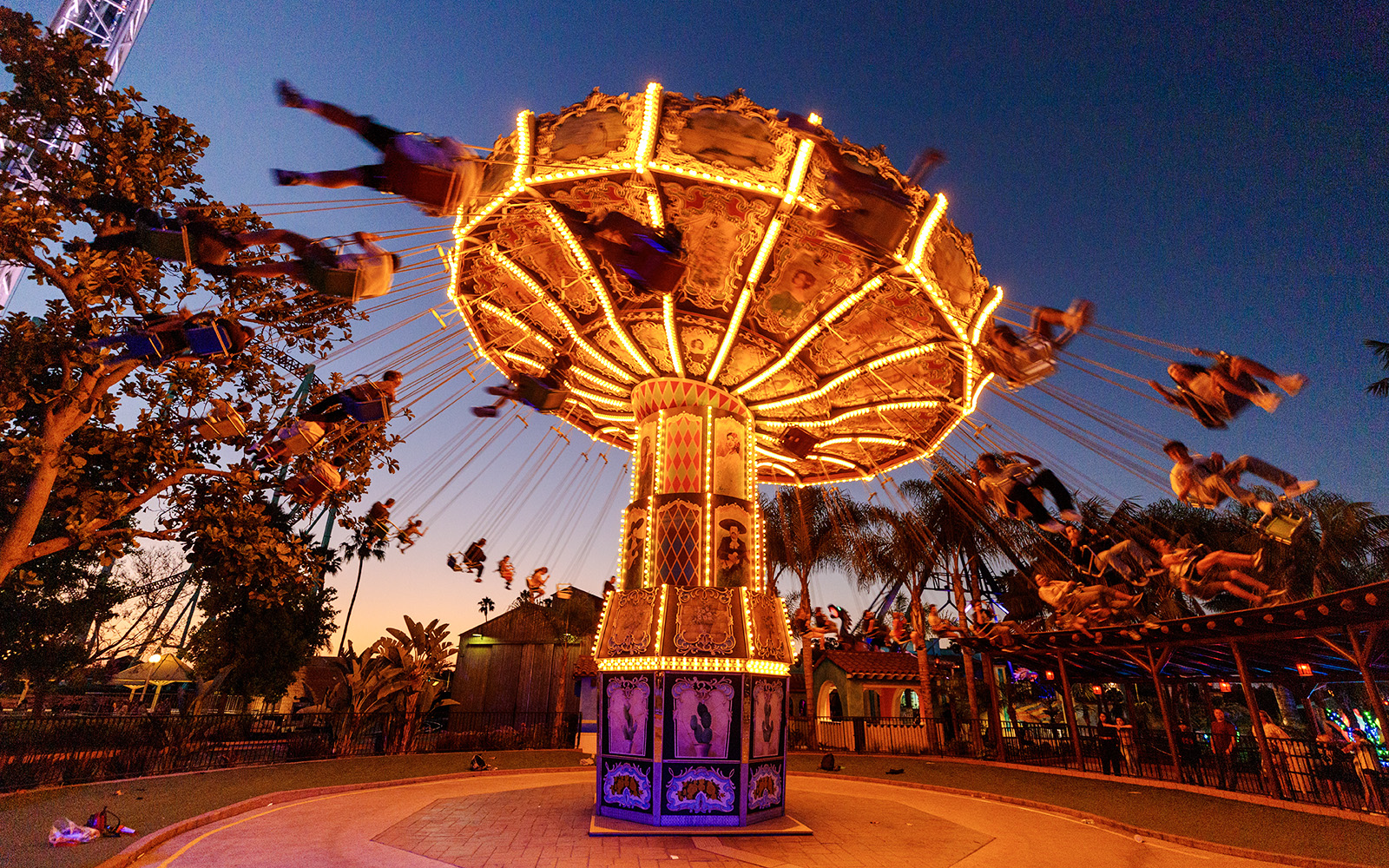 Los Voladores swing ride illuminated at dusk, Knott's Berry Farm.