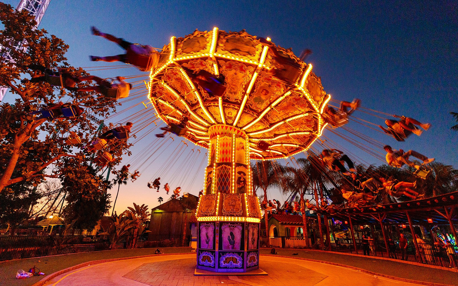Los Voladores swing ride illuminated at dusk, Knott's Berry Farm.