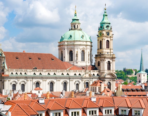 St. Nicholas Church in Prague with its iconic green dome and baroque architecture.