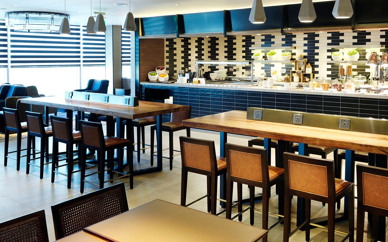 Plaza Premium Lounge seating and dining area at Terminal 4, London Heathrow Airport.