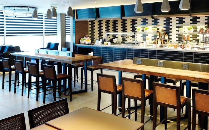 Plaza Premium Lounge seating and dining area at Terminal 4, London Heathrow Airport.