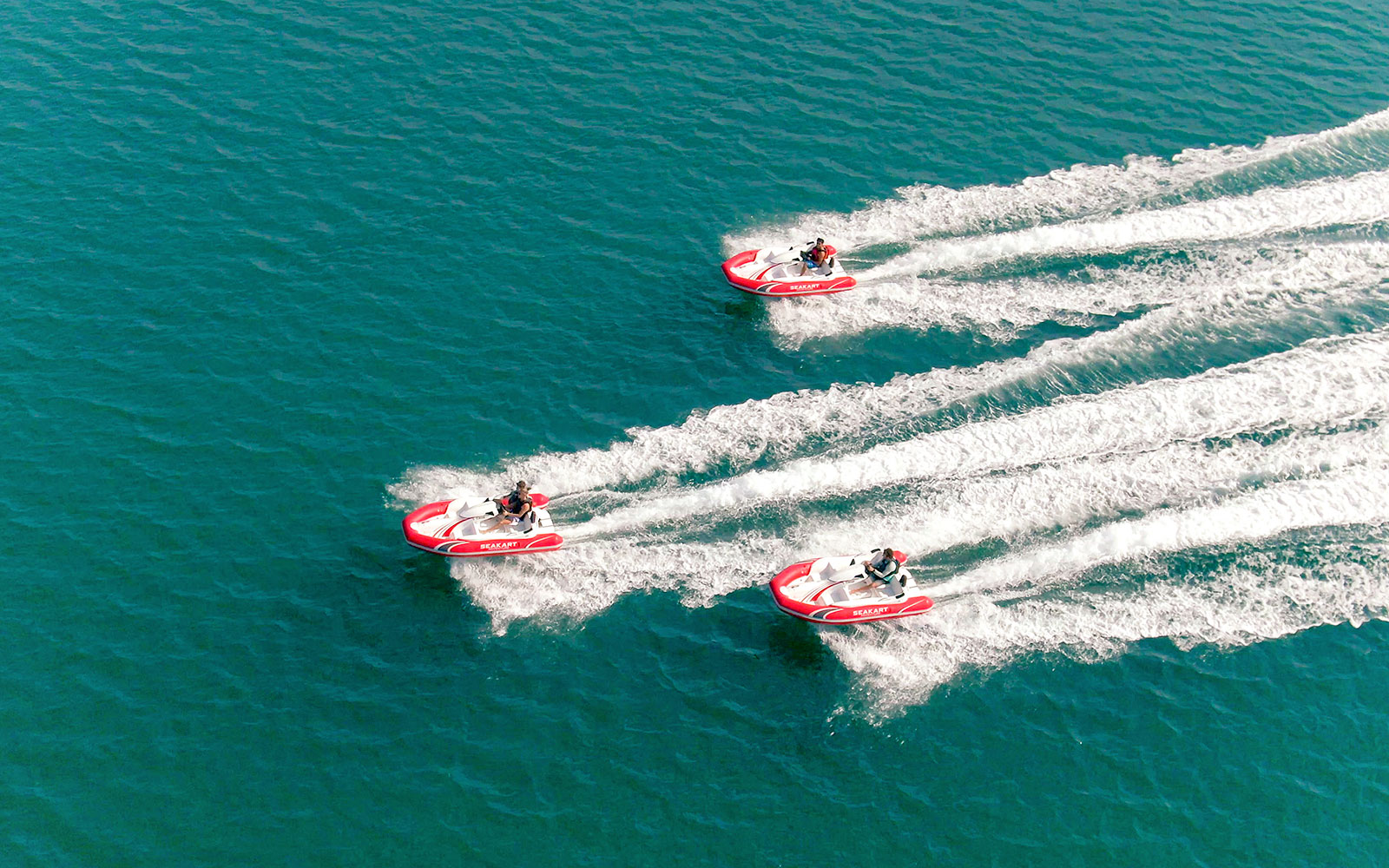 Seakart jet skis racing on blue waters in Dubai.