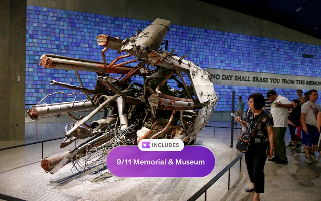 Wreckage display at 9/11 Memorial and Museum with visitors observing.