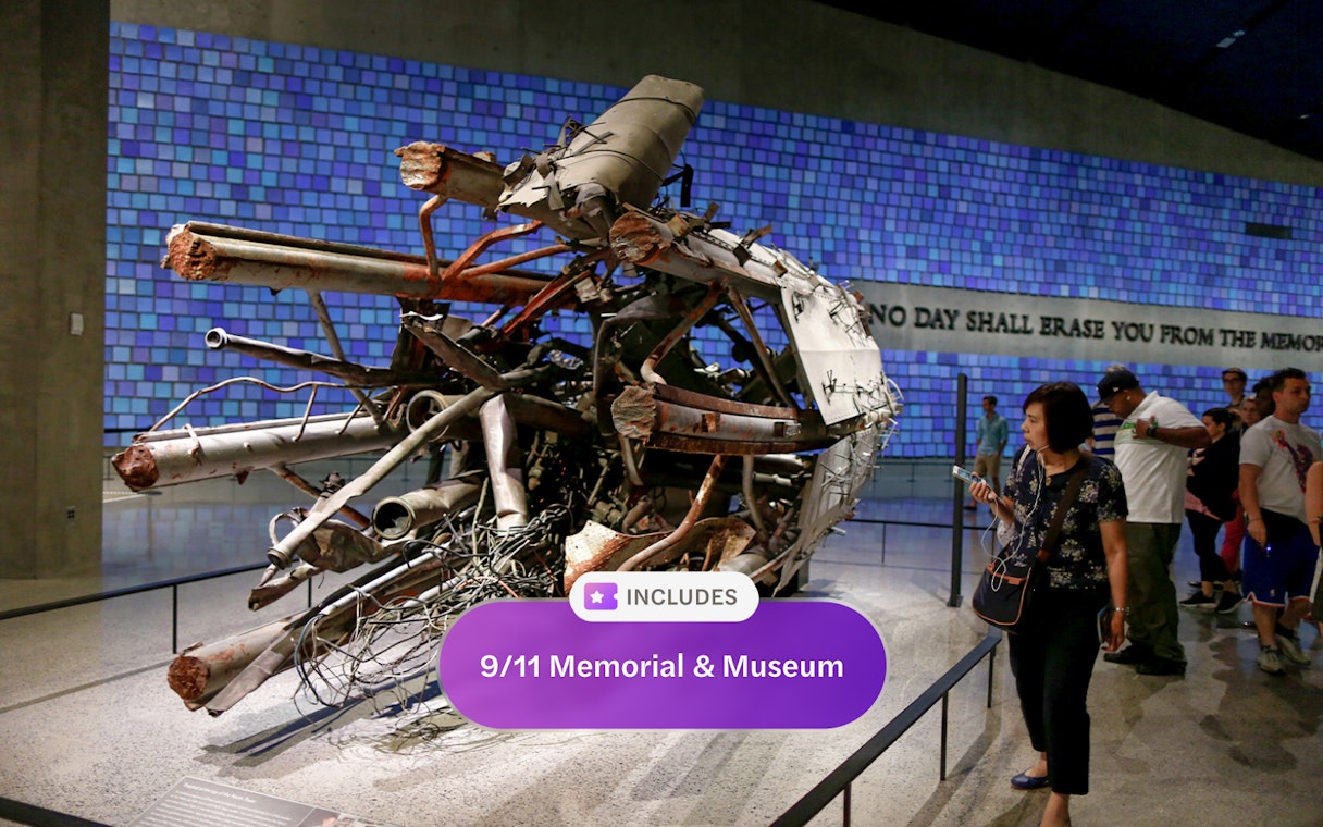 Wreckage display at 9/11 Memorial and Museum with visitors observing.