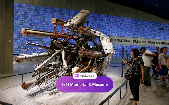 Wreckage display at 9/11 Memorial and Museum with visitors observing.