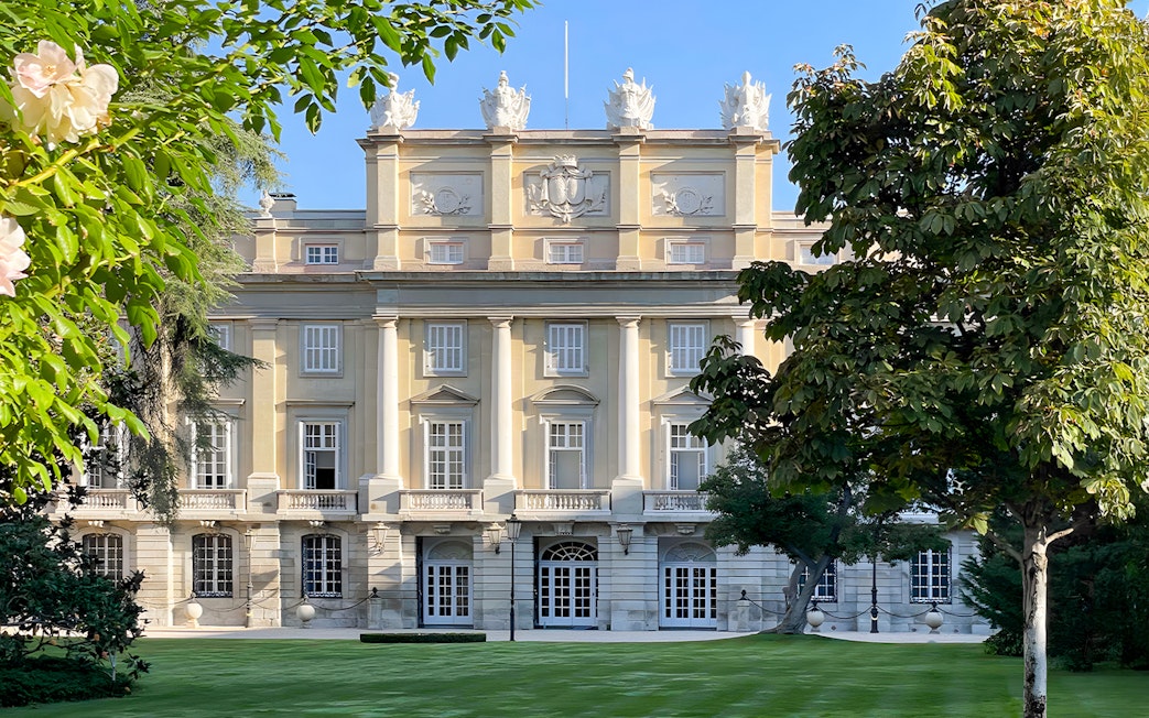Liria Palace facade with neoclassical architecture in Madrid, surrounded by lush greenery.