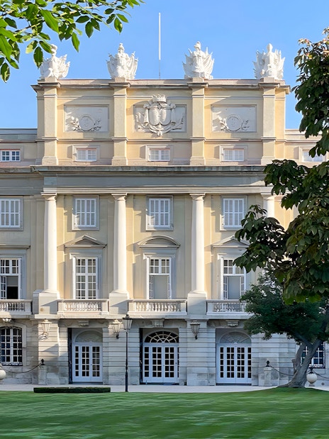 Liria Palace facade with neoclassical architecture in Madrid, surrounded by lush greenery.
