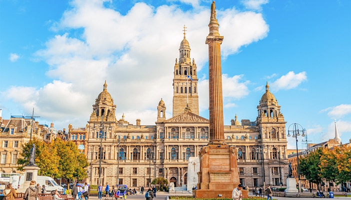 George Square in Glasgow with City Chambers and column statue, United Kingdom.
