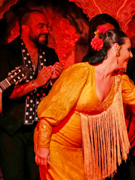 Flamenco dancers performing at Tablao Cordobes in vibrant costumes.