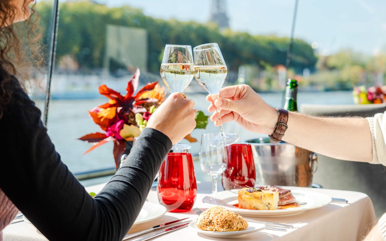 Toasting with champagne on a Bateaux Mouches Seine River cruise in Paris.