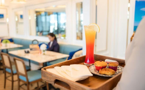 Tray with drink and pastries at Coral Lounge, Phuket International Airport.