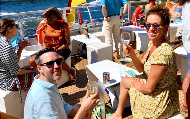 Guests enjoying drinks on a Christmas cruise in Berlin.