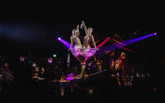 Performers in a giant martini glass at Burlesque Dinner Club, Vienna.