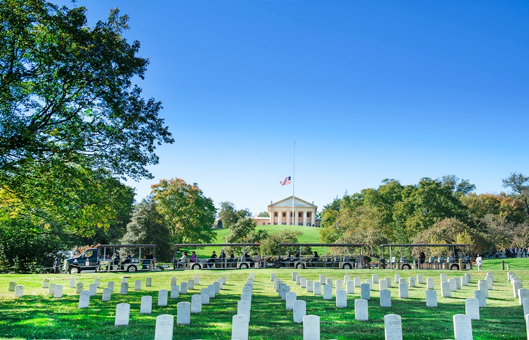 Tram tour at Arlington National Cemetery with Memorial in background, Washington, D.C.