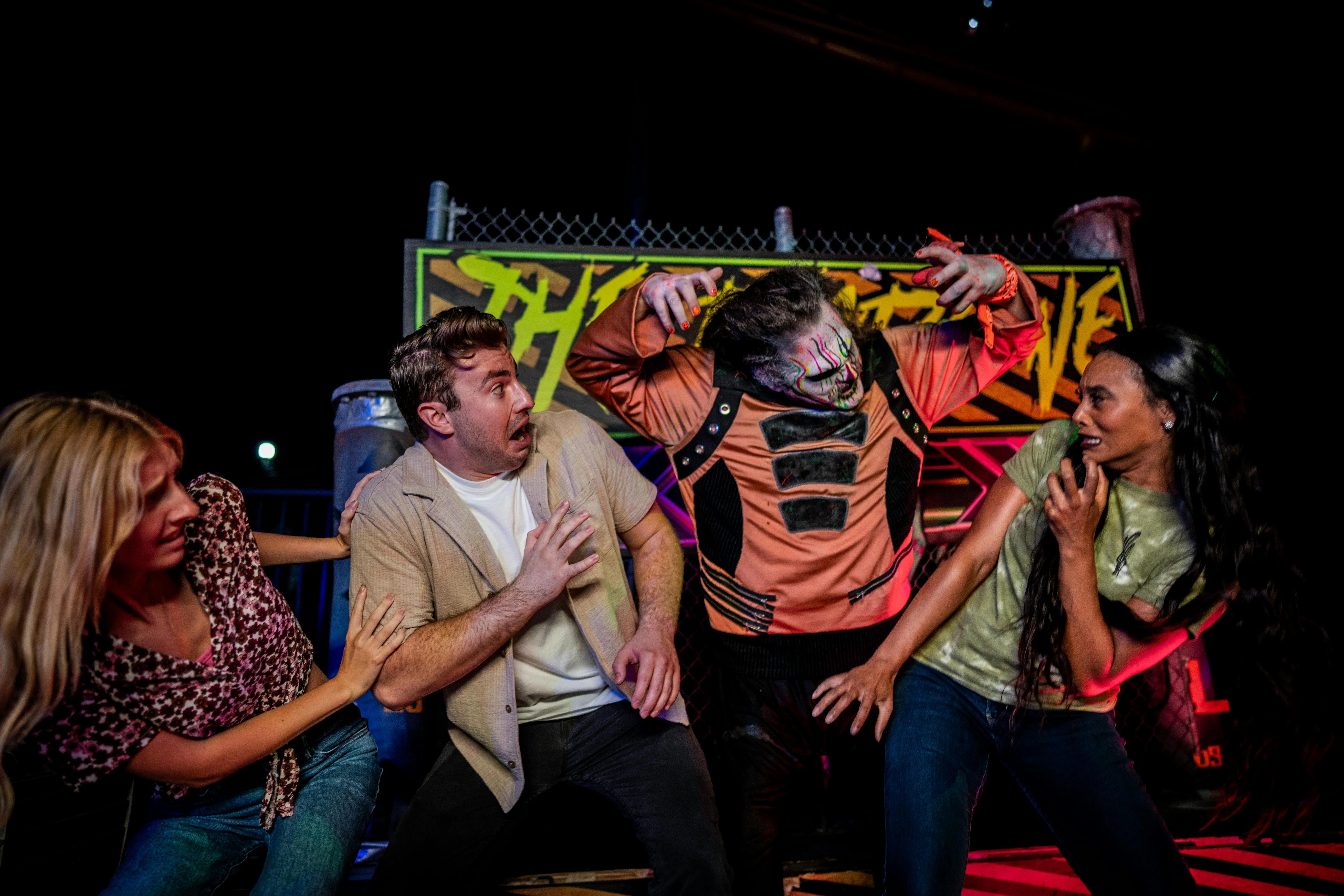 Group reacting to a costumed performer at Canada's Wonderland Halloween Haunt.