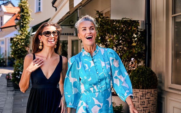 People enjoying a walk in La Vallée Village, Paris, France.