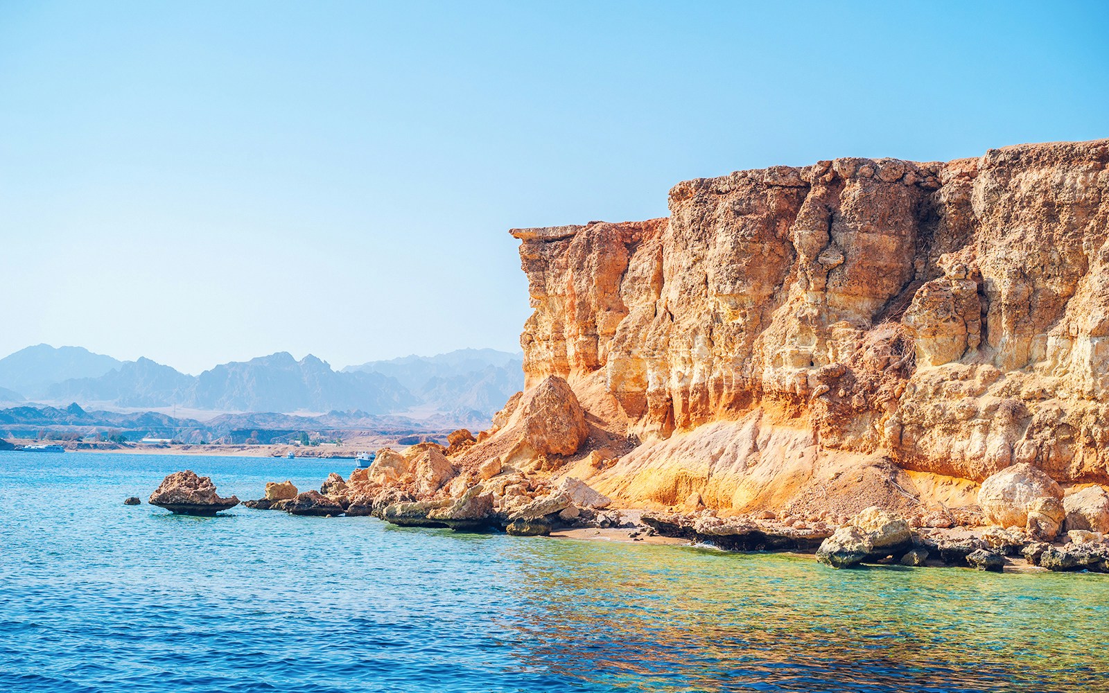 Rocky coastline of Ras Mohamed National Park with clear blue water.