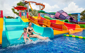 Mother and child enjoying a water slide at Wild Wild Wet, Singapore.