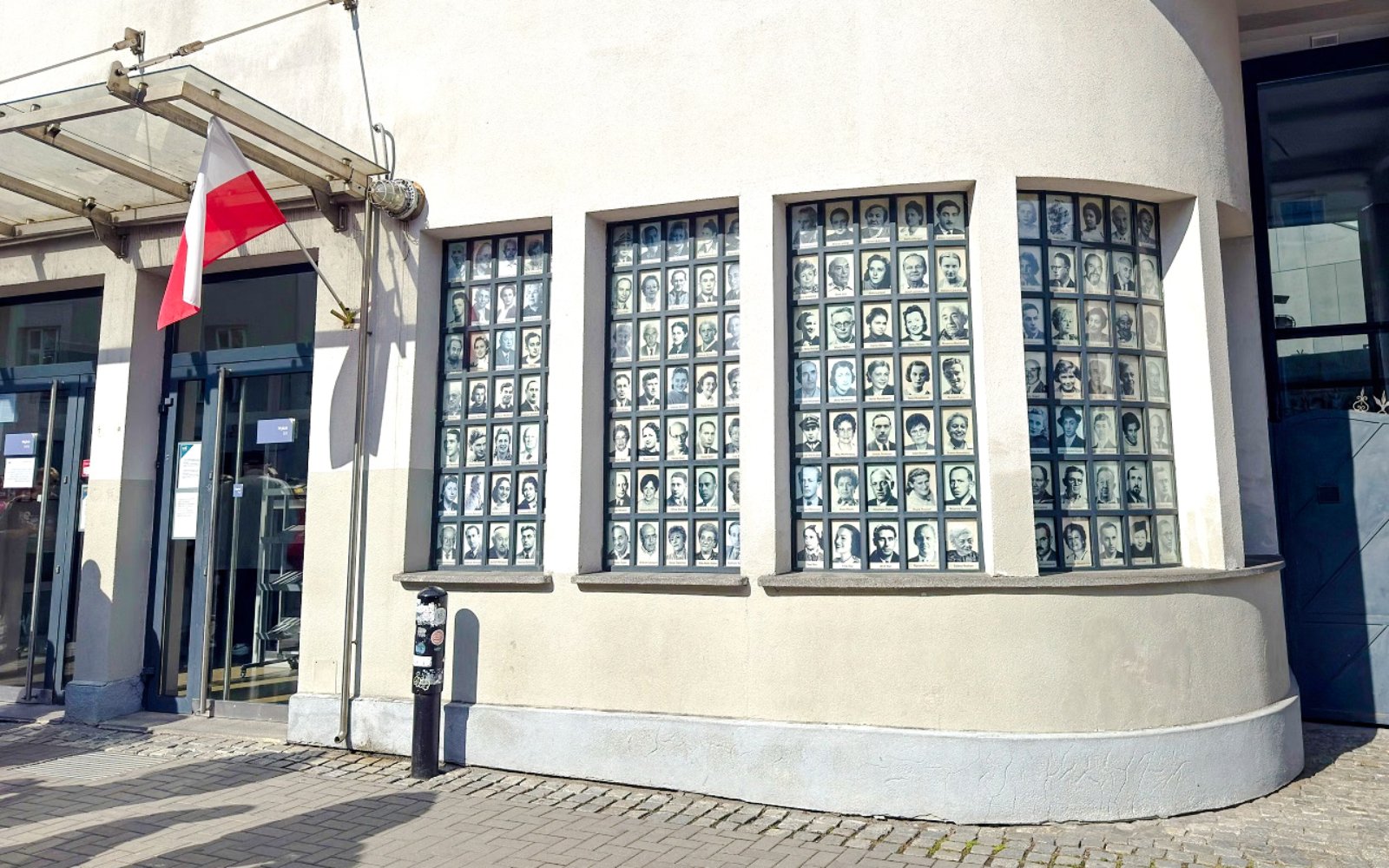 Oskar Schindler’s Factory exterior with photo display and Polish flag, Krakow, Poland.