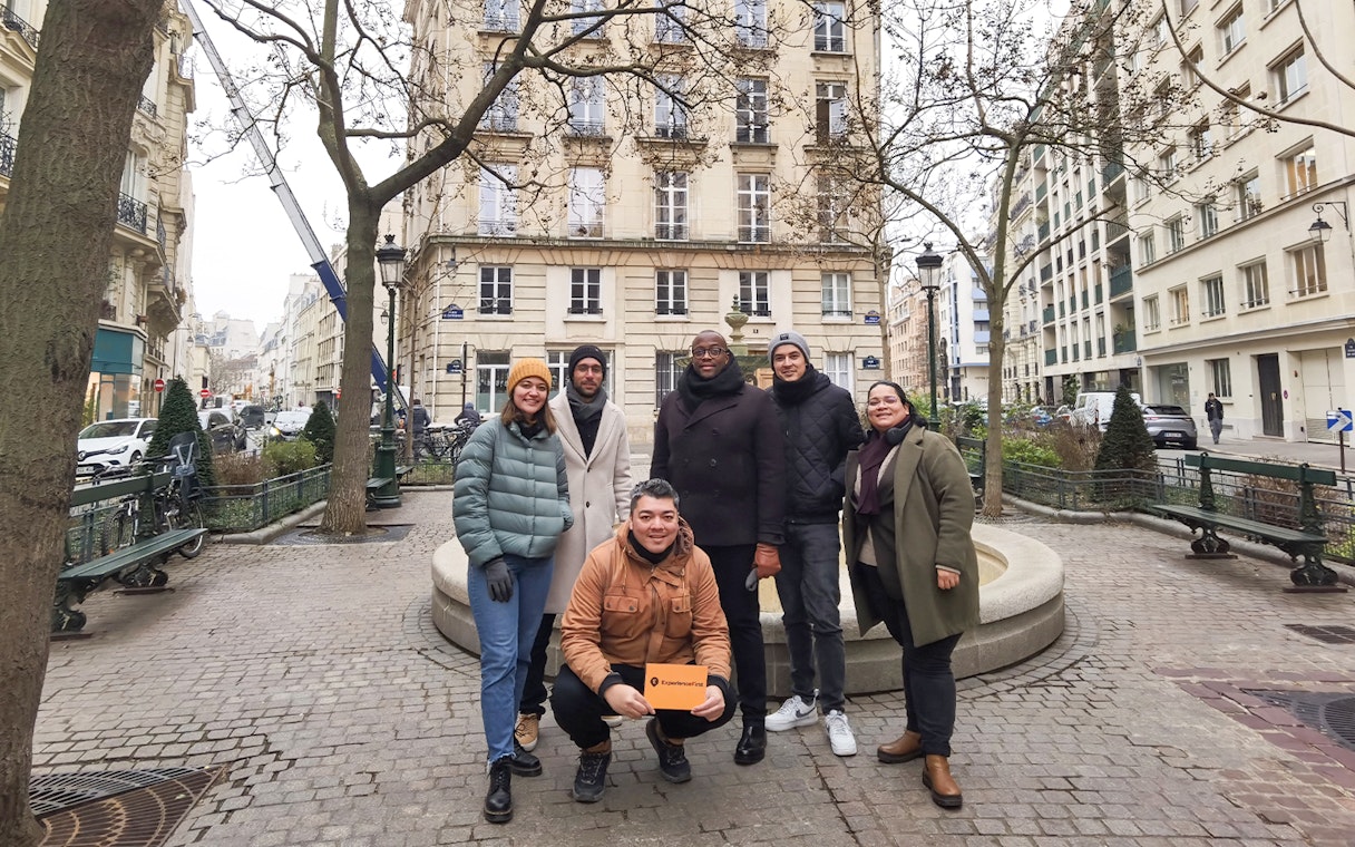 Group of tourists on the Emily in Paris Selfie Tour in a Parisian street.