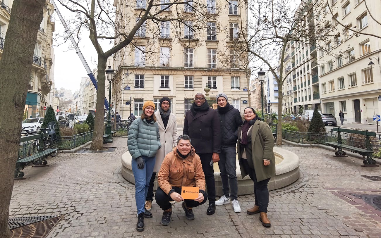 Group of tourists on the Emily in Paris Selfie Tour in a Parisian street.