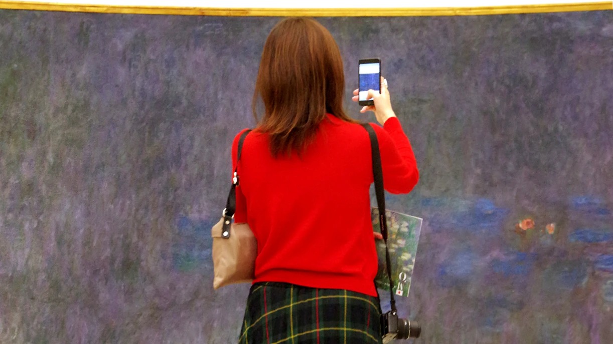 Visitor viewing Monet’s Water Lilies at the Orangerie Museum