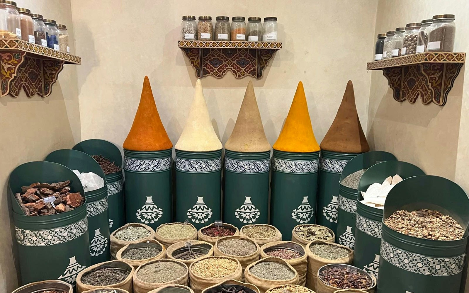 Spice display at Moroccan Culinary Art Museum with colorful cones and jars.