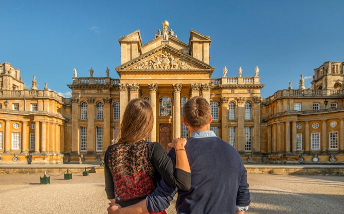 Visitors admiring the grand facade of Blenheim Palace in Oxfordshire.