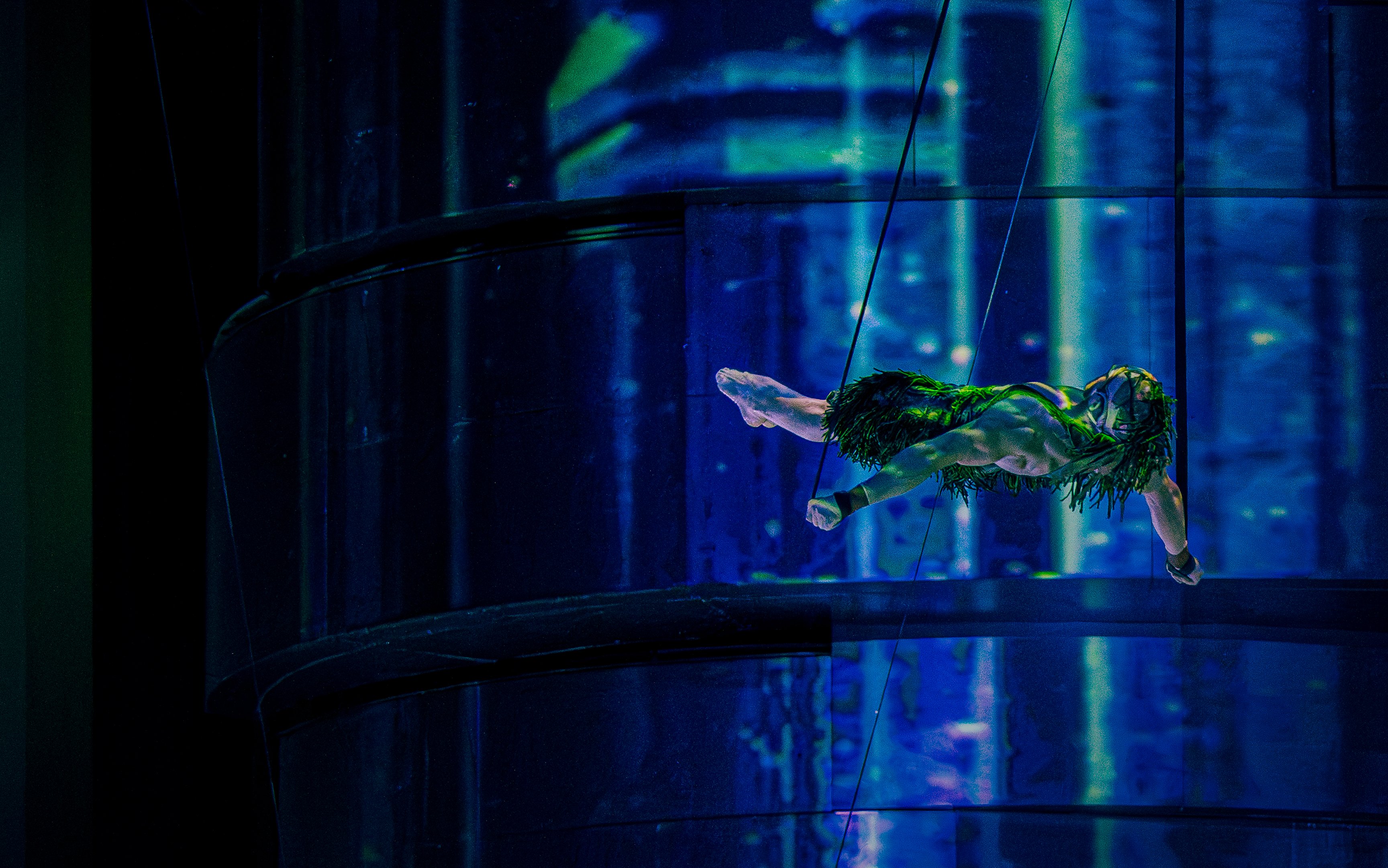 Aerial performer suspended in mid-air during La Perle show, Dubai.