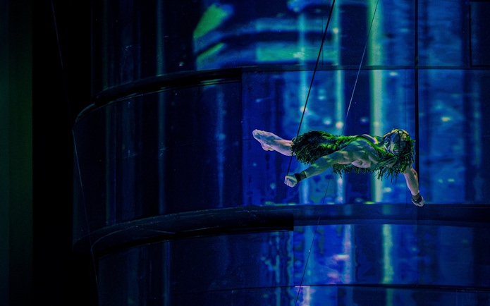 Aerial performer suspended in mid-air during La Perle show, Dubai.
