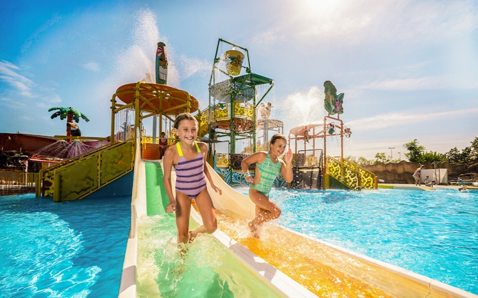 Children enjoying a water slide at Isla Mágica, Seville.