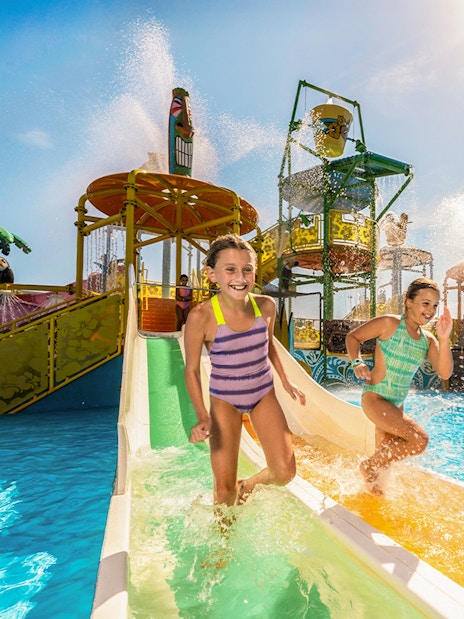 Children enjoying a water slide at Isla Mágica, Seville.
