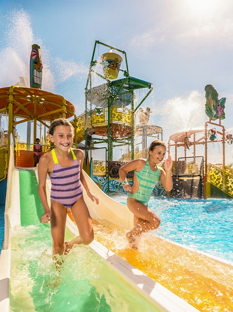 Children enjoying a water slide at Isla Mágica, Seville.
