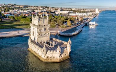 Belem Tower in Lisbon, Portugal, surrounded by the Tagus River, viewed from above.