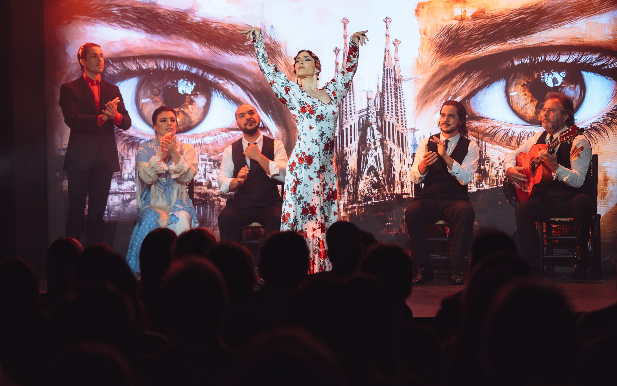 Flamenco dancers performing at Teatro Flamenco Barcelona with Sagrada Familia backdrop.