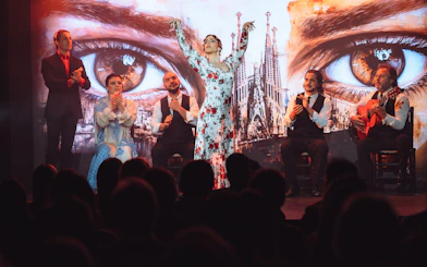 Flamenco dancers performing at Teatro Flamenco Barcelona with Sagrada Familia backdrop.