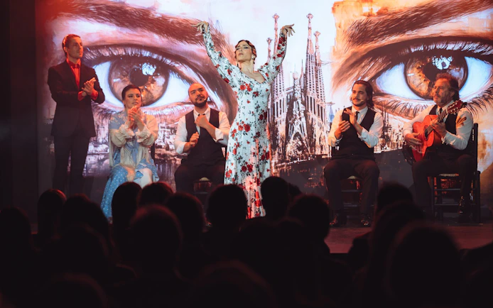 Flamenco dancers performing at Teatro Flamenco Barcelona with Sagrada Familia backdrop.