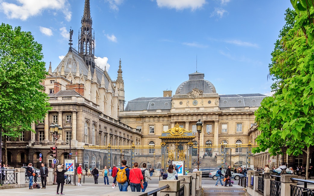 Sainte Chapelle exterior with ornate spire and surrounding architecture in Paris.