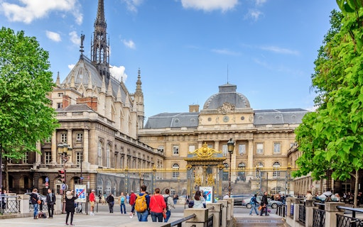 Sainte Chapelle exterior with ornate spire and surrounding architecture in Paris.