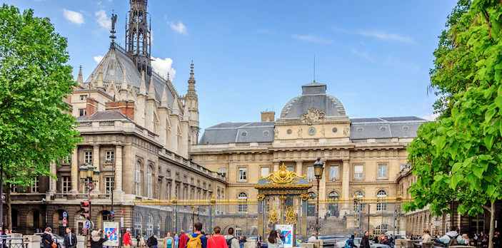 Sainte Chapelle exterior with ornate spire and surrounding architecture in Paris.
