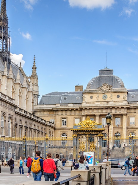 Sainte Chapelle exterior with ornate spire and surrounding architecture in Paris.
