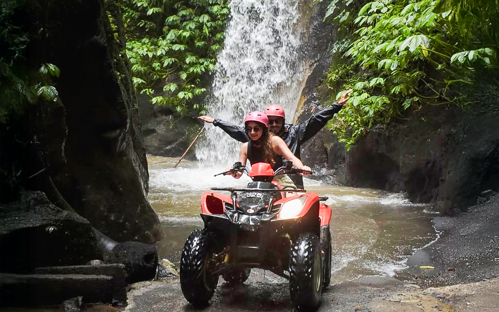 ATV ride through Kuber long tunnel with waterfall backdrop.
