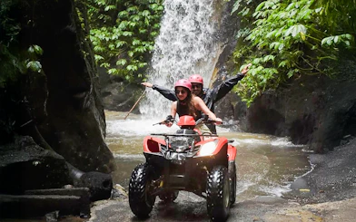 ATV ride through Kuber long tunnel with waterfall backdrop.