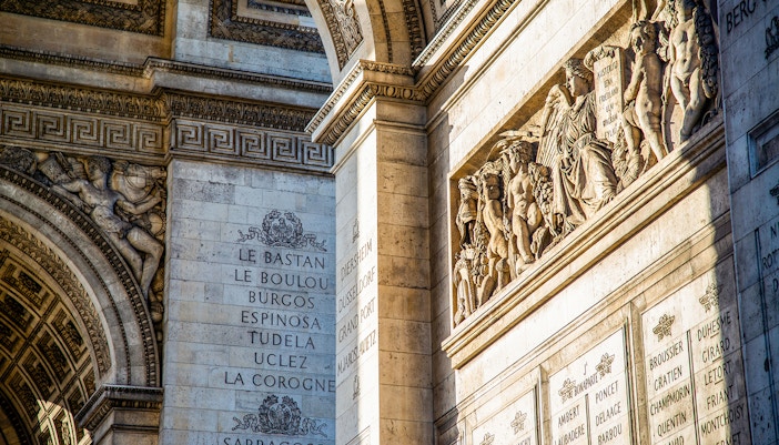 Arc de Triomphe interior carvings and inscriptions during guided tour.