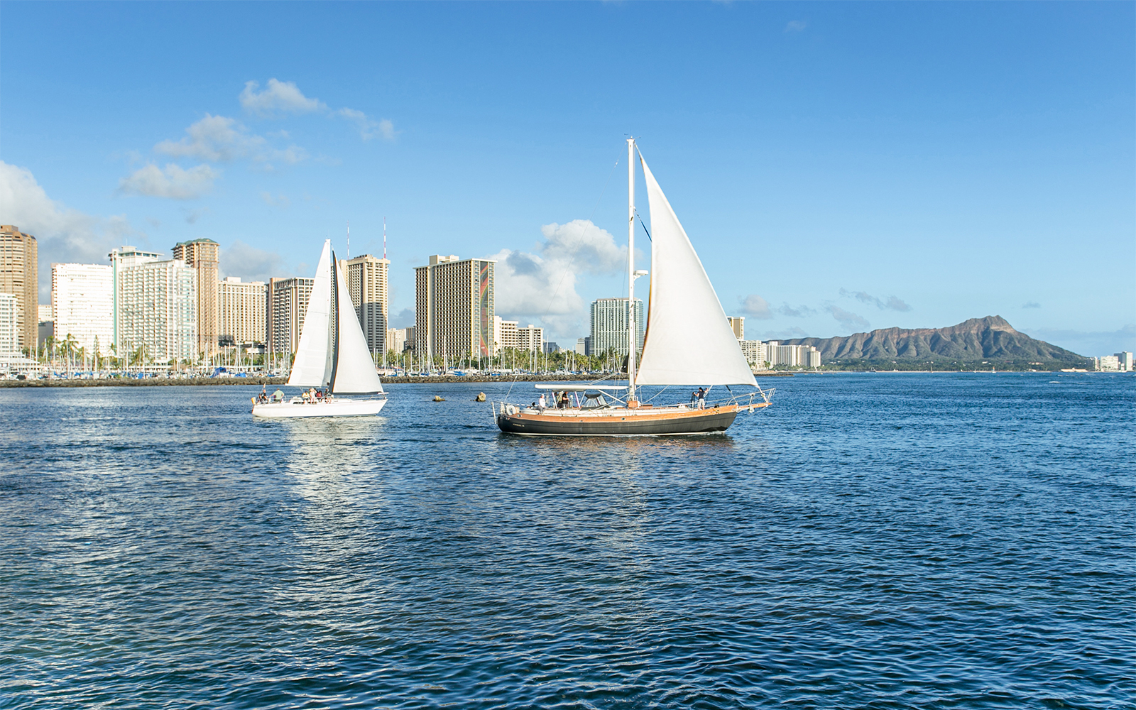 Sail boat with Diamond head mountain Hawaii background, Oahu, Hawaii